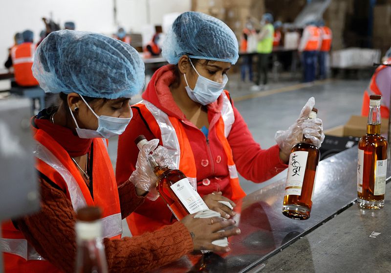 &copy; Reuters. Workers prepare to pack whisky bottles inside Piccadily Distilleries, in Indri, in the northern state of Haryana, India, December 14, 2023. REUTERS/Sahiba Chawdhary