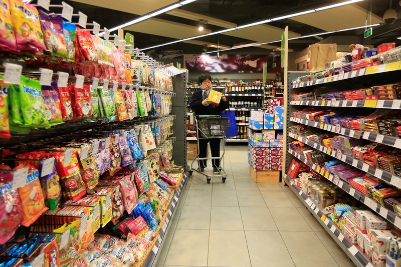 &copy; Reuters. FILE PHOTO: A customer selects products at a supermarket in Shanghai, February 10, 2015. REUTERS/Aly Song/File Photo