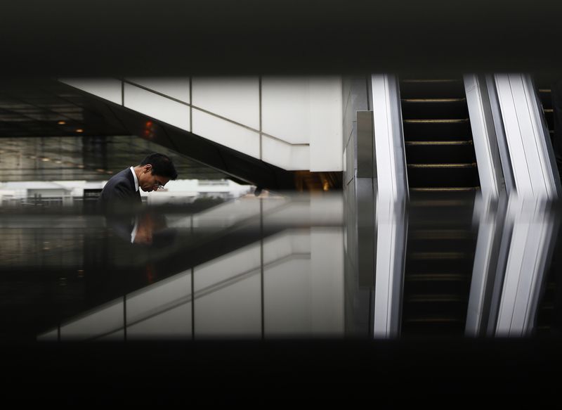 &copy; Reuters. FILE PHOTO: A pedestrian walks along a street at a business district in Tokyo October 31, 2014. REUTERS/Yuya Shino /File Photo