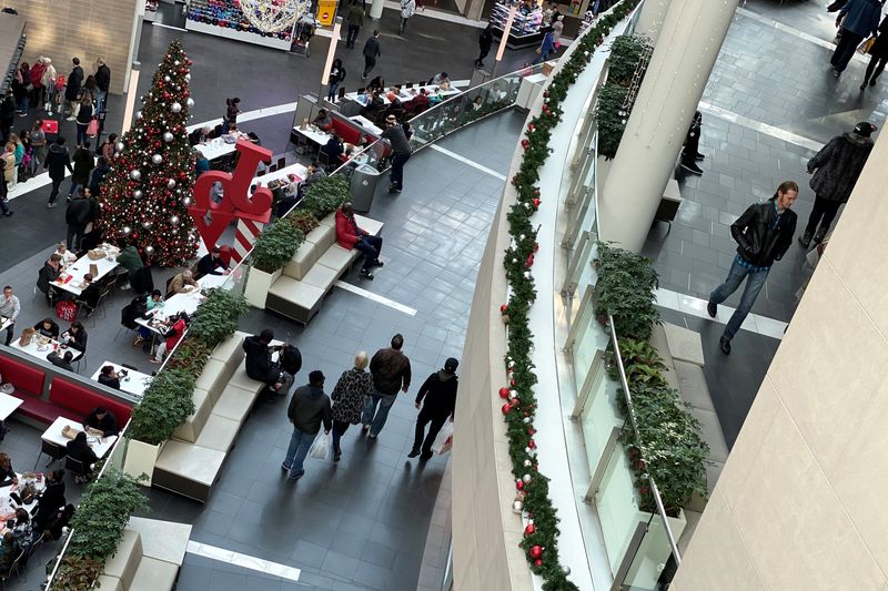 &copy; Reuters. FILE PHOTO: Shoppers make their way through Fashion Centre at Pentagon City, decorated for the holidays, in Arlington, Virginia, U.S. December 23, 2019. REUTERS/Jonathan Ernst/File Photo