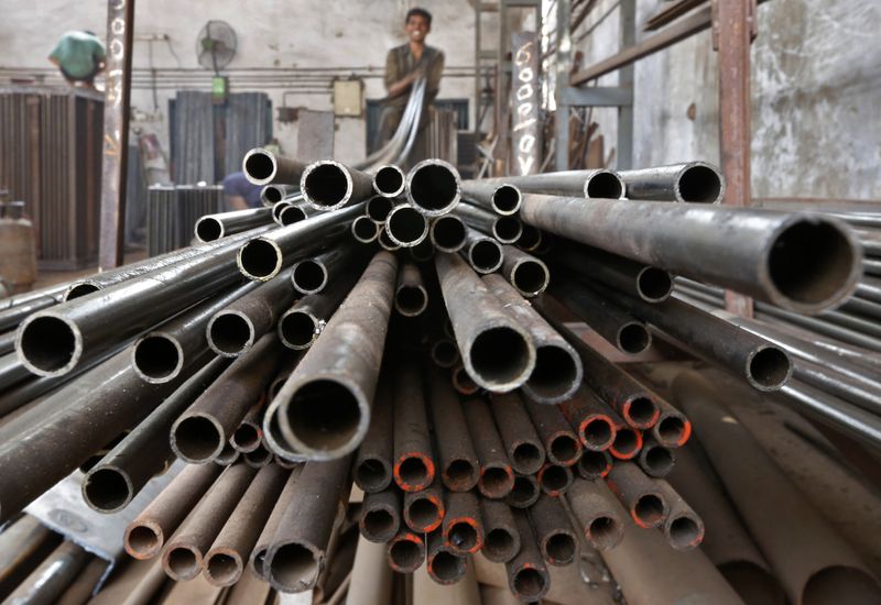 &copy; Reuters. A worker stacks steel pipes in the western Indian city of Ahmedabad November 4, 2014. REUTERS/Amit Dave/Files