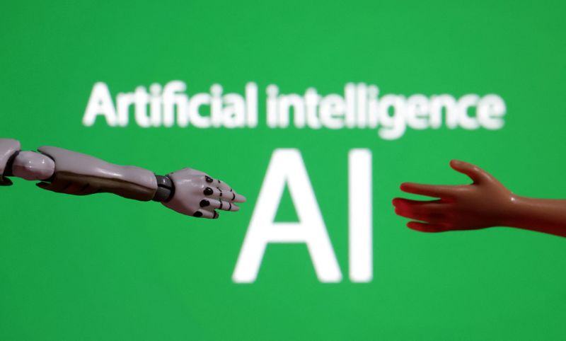 &copy; Reuters. Des mots "Intelligence artificielle IE" et une miniature de robot et de main de jouet. /Photo d'illustration prise le 14 décembre 2023/REUTERS/Dado Ruvic