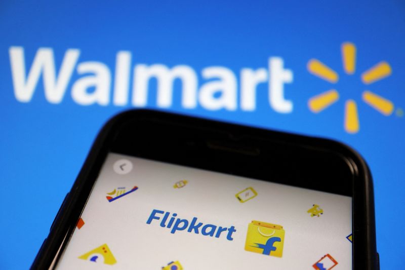 © Reuters. FILE PHOTO: A mobile phone showing an image of Indian online retailer Flipkart is seen in front of a Walmart Inc logo displayed in this illustration picture taken July 14, 2021. REUTERS/Florence Lo/Illustration/File Photo