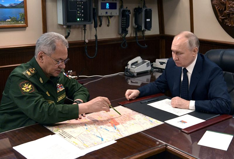 &copy; Reuters. １２月２５日、ロシアのショイグ国防相（左）は、プーチン大統領（右）にウクライナ東部ドネツク州の激戦地マリンカを完全に制圧したと伝えた。サンクトペテルブルクで同日撮影。提供