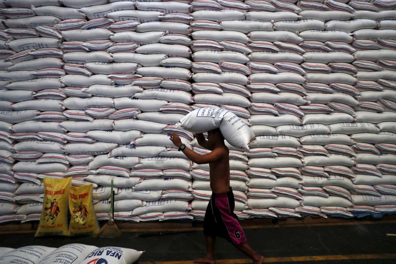 &copy; Reuters. A worker carries on his head a sack of rice inside a government rice warehouse National Food Authority in Quezon city, Metro Manila in Philippines, August 9, 2018. REUTERS/Erik De Castro/Files