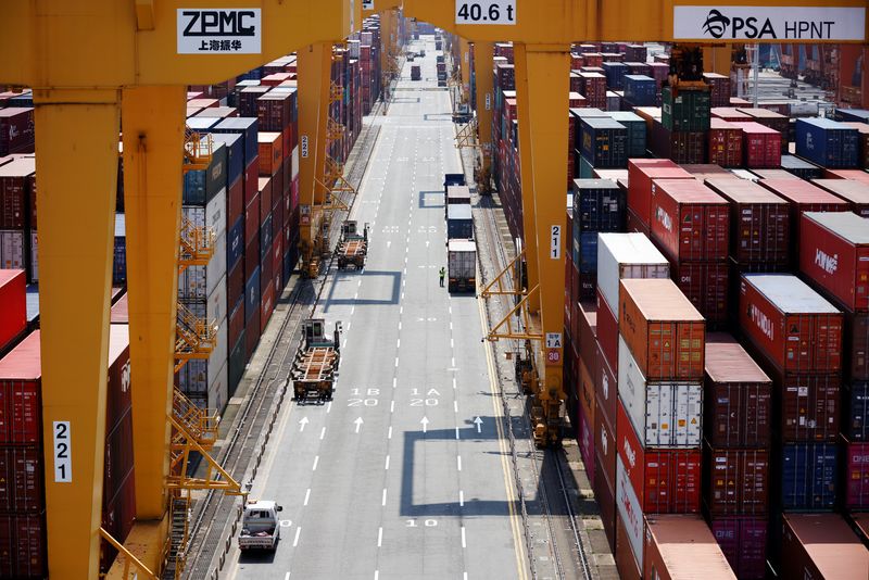 &copy; Reuters. A truck driver stands next to his truck as he gets ready to transport a shipping container at Pusan Newport Terminal in Busan, South Korea, July 1, 2021. Picture taken on July 1, 2021. REUTERS/Kim Hong-Ji/file photo