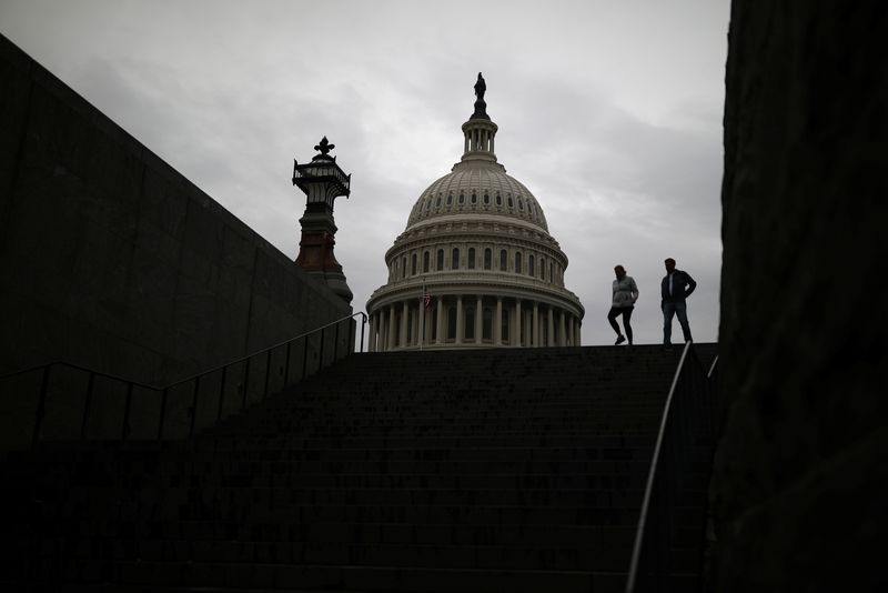 &copy; Reuters. Pedestrians walk along the East Front of the U.S. Capitol Building on Capitol Hill in Washington, U.S., December 4, 2020. REUTERS/Tom Brenner/File Photo