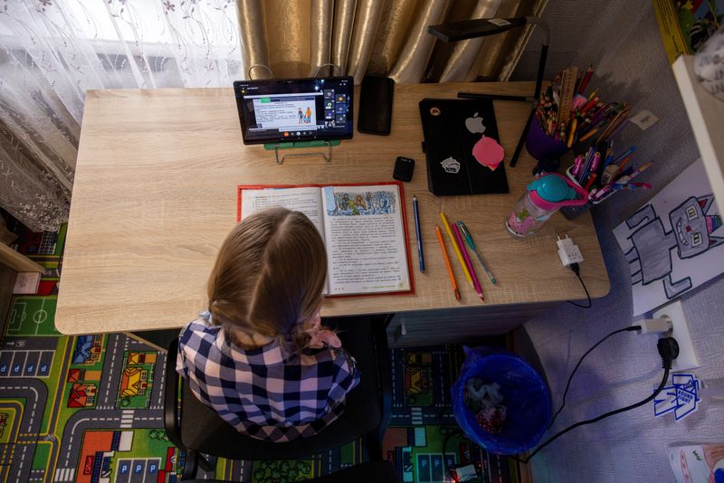 &copy; Reuters. Ukrainian third-grader Arina Herasymova attends an online reading class in her bedroom in Sloviansk, amid Russia's attack on Ukraine, December 20, 2023. Ukrainian third-grade student Arina has had just over 1.5 months of in-class schooling because of the 