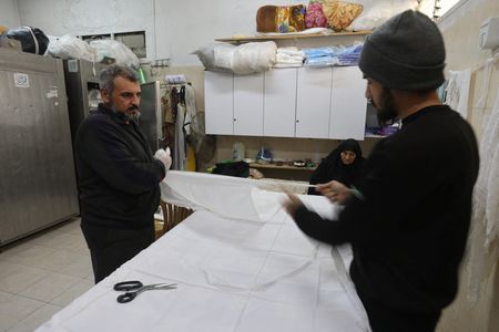 In Gaza, rows of white shrouds symbolise mounting civilian deaths By Reuters