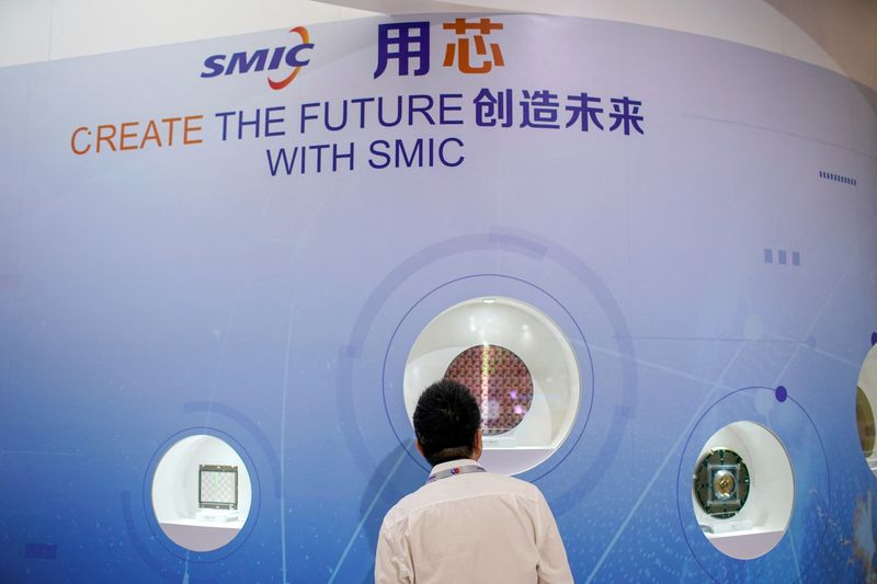 &copy; Reuters. FILE PHOTO: A man visits a booth of Semiconductor Manufacturing International Corporation (SMIC), at China International Semiconductor Expo (IC China 2020) in Shanghai, China October 14, 2020. REUTERS/Aly Song/File Photo  To match Special Report USA-CHINA