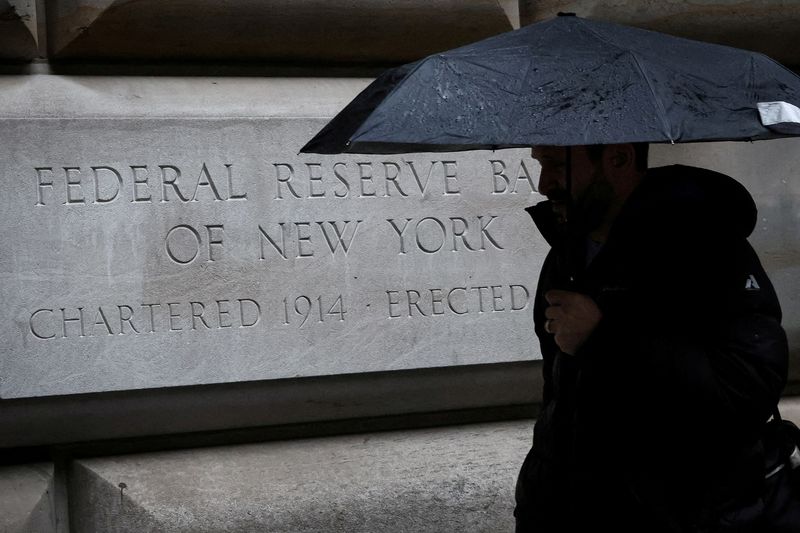 &copy; Reuters. FILE PHOTO: A man passes by the Federal Reserve Bank of New York in New York City, U.S., March 13, 2023. REUTERS/Brendan McDermid/File Photo