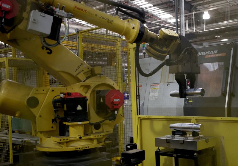 &copy; Reuters. FILE PHOTO: A robot arm lifts a partially completed 155mm shell casing near a lathe on the production line at the BAE munitions factory in Washington, Britain, November 8, 2023. REUTERS/Phil Noble/File Photo