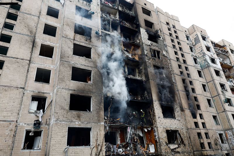 © Reuters. رجال إطفاء يعملون في موقع مبنى سكني تعرض لأضرار بالغة جراء هجوم صاروخي روسي في كييف بأوكرانيا يوم الثلاثاء. تصوير: فالنتين أوجيرنكو - رويترز.

