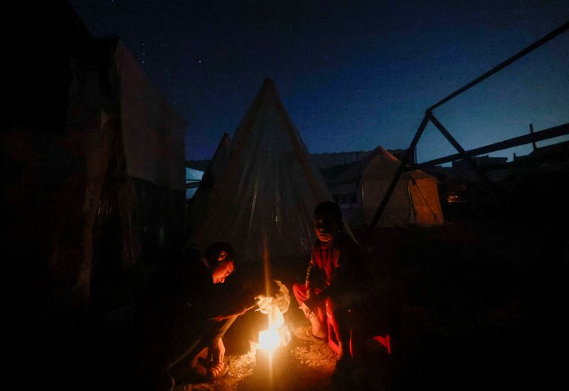 For Gaza family living in tent city, campfire is the only home