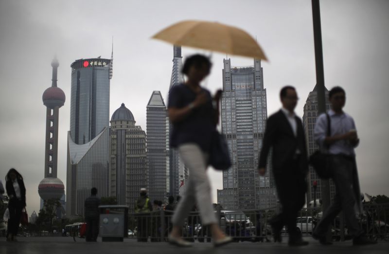 &copy; Reuters. FILE PHOTO: People walk along an avenue at Pudong financial district in Shanghai May 30, 2013.REUTERS/Carlos Barria/File Photo