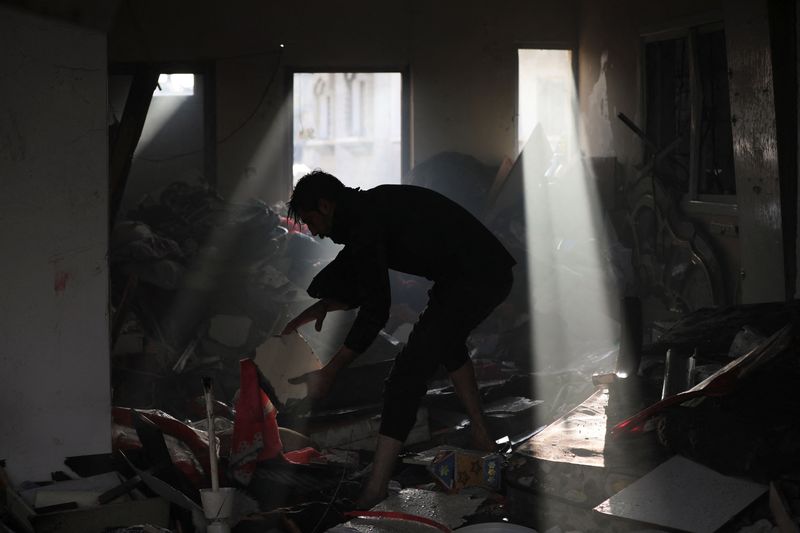 &copy; Reuters. Palestino recoge escombros en el lugar de un ataque israelí en el campo de refugiados de Maghazi, en el centro de la Franja de Gaza, en medio del actual conflicto entre Israel y el grupo islamista palestino Hamás, 3 de enero de 2024. REUTERS/Mohammed Al