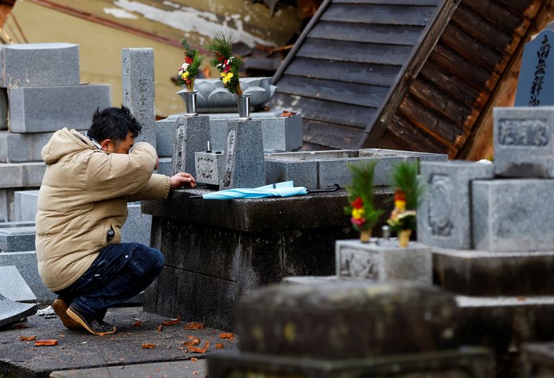 &copy; Reuters. A man who lost his house in the earthquake reacts as he visits the graveyards of his parents, which were rattled by the earthquake, in Wajima, Japan, January 4, 2024. REUTERS/Kim Kyung-Hoon
