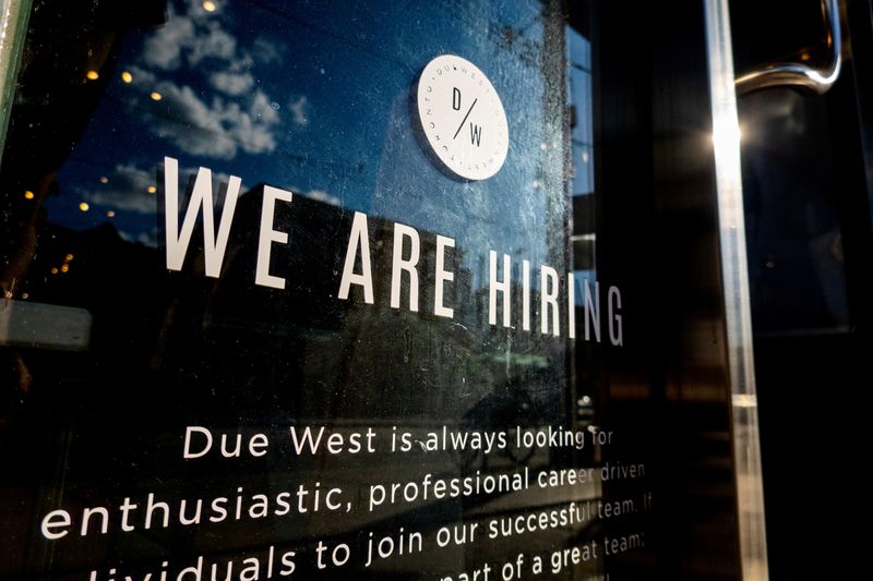 &copy; Reuters. FILE PHOTO: A help wanted sign at a store along Queen Street West in Toronto Ontario, Canada June 10, 2022. REUTERS/Carlos Osorio/File Photo