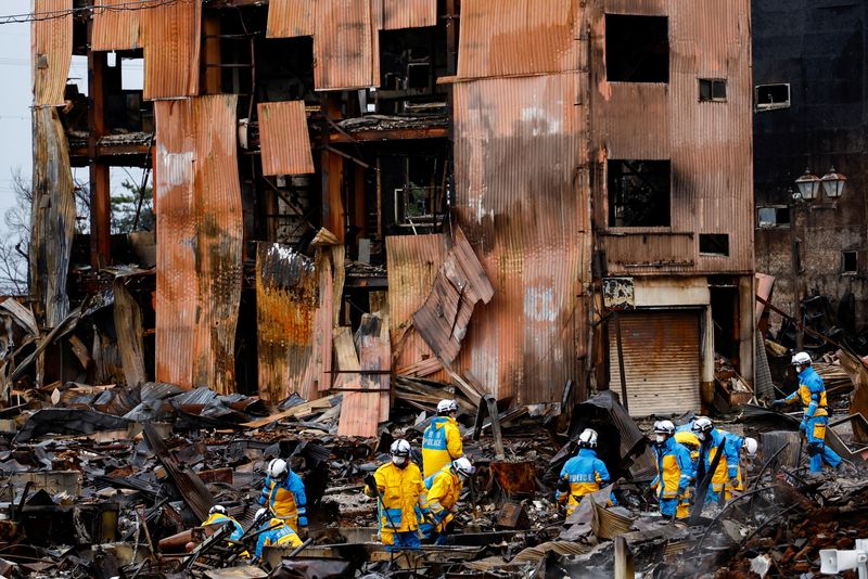 &copy; Reuters. رجال شرطة يبحثون عن ضحايا في شارع شهد حريقا في أعقاب الزلزال بمدينة واجيما في منطقة إيشيكاوا باليابان يوم الأحد. تصوير: كيم كيونج هوون - رويت