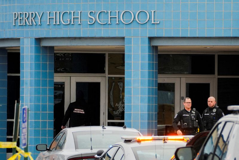 &copy; Reuters. A medical examiner enters the school as police respond to a school shooting at the Perry Middle School and High School complex in Perry, Iowa, U.S., January 4, 2024.  REUTERS/Cheney Orr/ File Photo