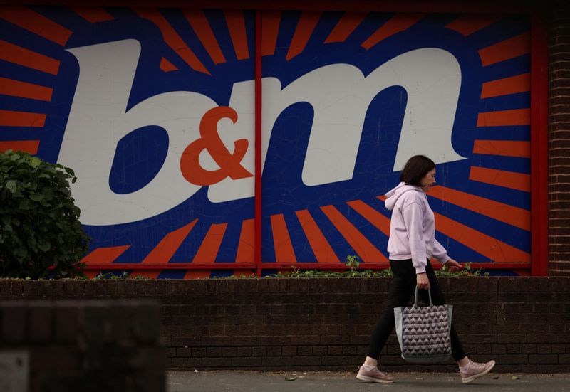 &copy; Reuters. A woman carrying a shopping bag walks past a B&M store in Manchester, Britain June 1, 2023. REUTERS/Phil Noble/File Photo