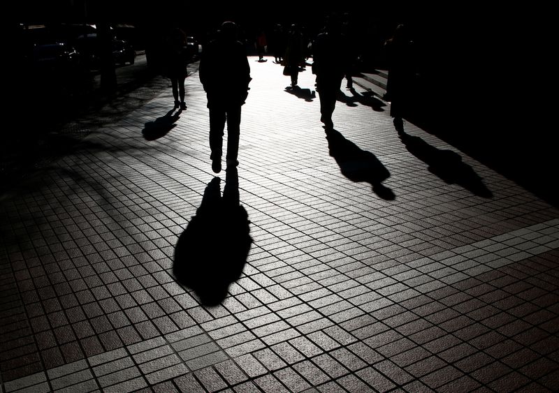 &copy; Reuters. FILE PHOTO: Pedestrians cast shadows as they make their way at a financial district in Tokyo, Japan, January 26, 2017. Picture taken on January 26, 2017.   REUTERS/Kim Kyung-Hoon/File Photo