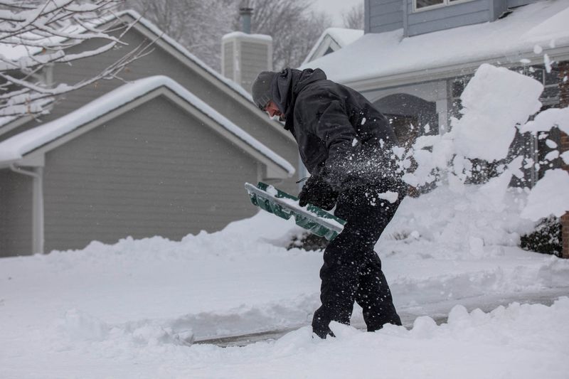 &copy; Reuters. FILE PHOTO: Zach Brobst shovels in his driveway after a snowstorm left several inches of snow in Clive, Iowa, U.S., January 9, 2024. REUTERS/Alyssa Pointer/File Photo