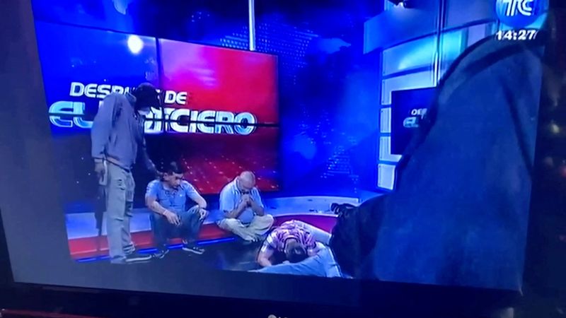 &copy; Reuters. Workers lie on the floor as hooded and armed people take over a tv studio of Ecuador's TV station TC during a live broadcast, in this still image of a Reuters' recording of the affair of TC signal channel, in Guayaquil, Ecuador, January 9, 2024. Reuters T