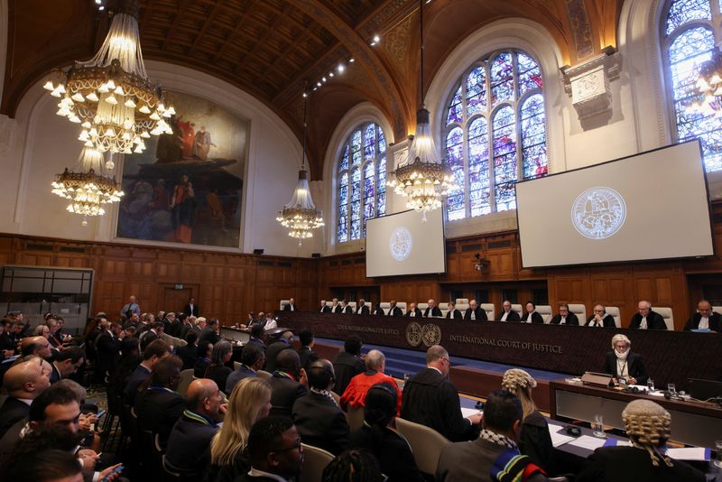 &copy; Reuters. People sit inside the International Court of Justice (ICJ) on the day of the trial to hear a request for emergency measures by South Africa, who asked the court to order Israel to stop its military actions in Gaza and to desist from what South Africa says