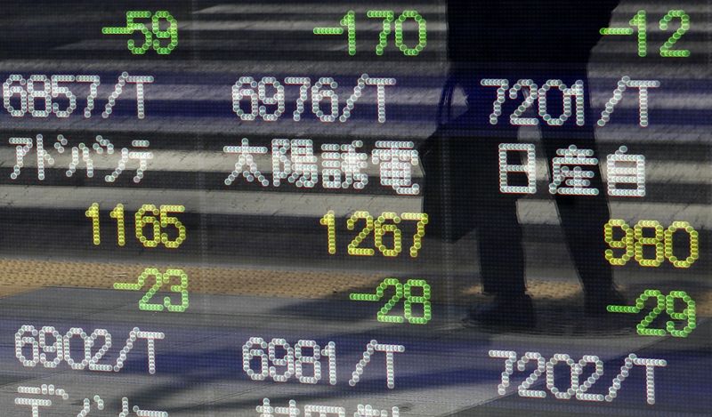 &copy; Reuters. A pedestrian is reflected on a stock quotation board displaying Japan's various stock prices outside a brokerage in Tokyo August 28, 2013.REUTERS/Yuya Shino /File Photo