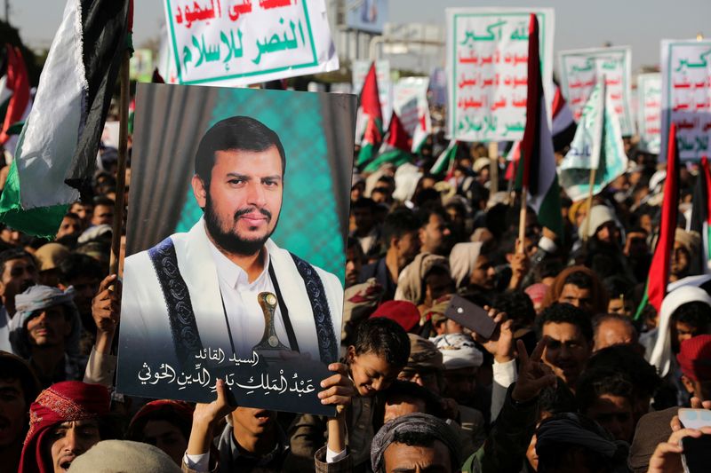 &copy; Reuters. A person holds a placard with a picture of Yemen's Houthi movement leader Abdul-Malik al-Houthi, as supporters of the Houthi movement rally to denounce air strikes launched by the U.S. and Britain on Houthi targets, in Sanaa, Yemen January 12, 2024. REUTE