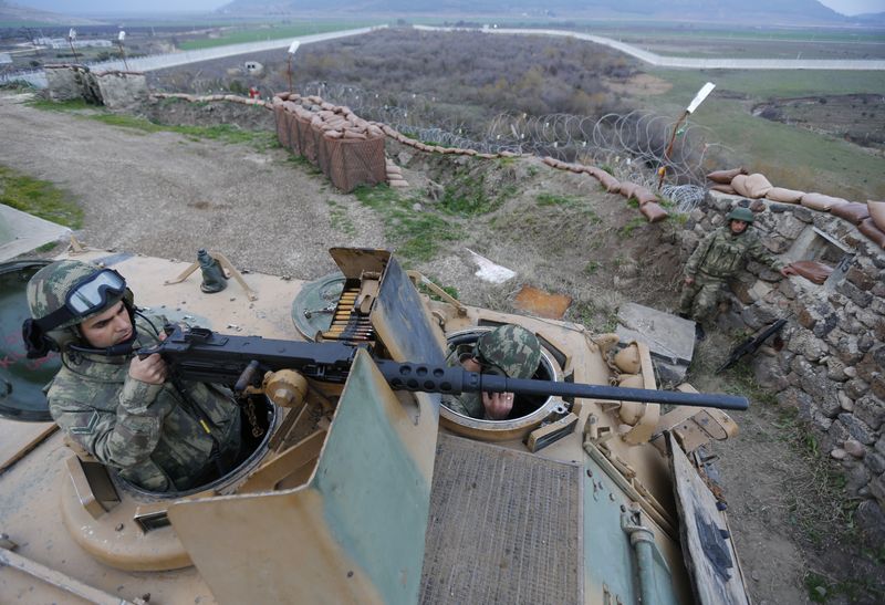 © Reuters. جنديان تركيان داخل مدرعة يقومان بمسح الخط الحدوي الفاصل بين تركيا وسوريا في صورة من أرشيف رويترز .  