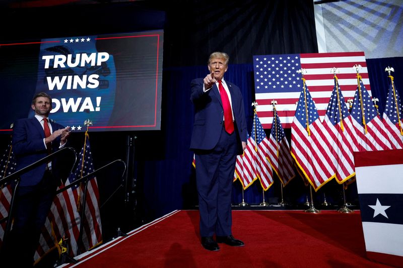&copy; Reuters. FILE PHOTO: Republican presidential candidate and former U.S. President Donald Trump gestures as his son Eric Trump applauds next to him during his Iowa caucus night watch party in Des Moines, Iowa, U.S., January 15, 2024.  REUTERS/Evelyn Hockstein/File P