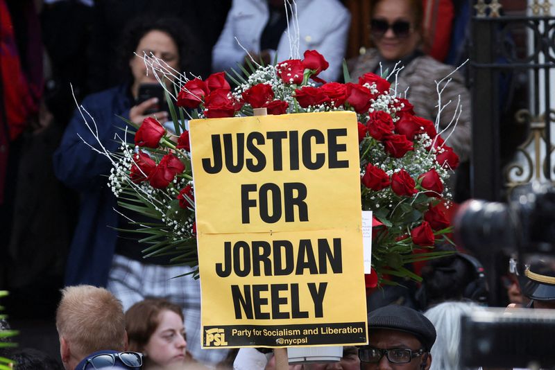 &copy; Reuters. FILE PHOTO: People hold a placard on the day of Jordan Neely's funeral, a man whose death has been ruled a homicide by the city's medical examiner after being placed in a chokehold on a subway train by former U.S. Marine Daniel Penny, in New York City, U.