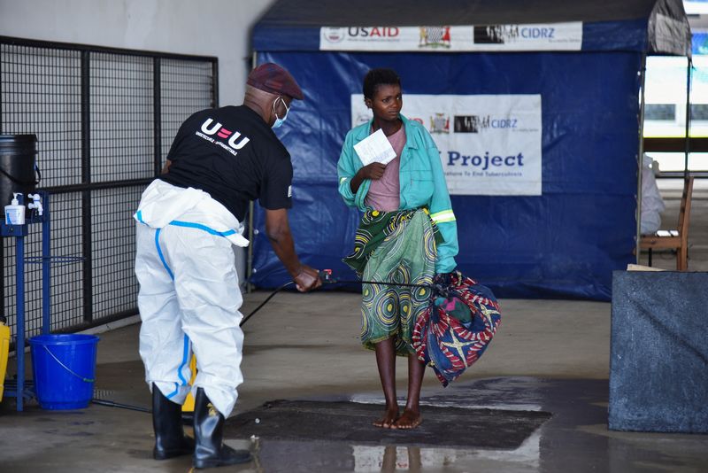 &copy; Reuters. A woman is disinfected as she arrives at a temporary cholera treatment centre which has been set up to deal with the latest deadly cholera outbreak at the Heroes National Stadium in Lusaka, Zambia January 17, 2024 REUTERS/Namukolo Siyumbwa/File Photo