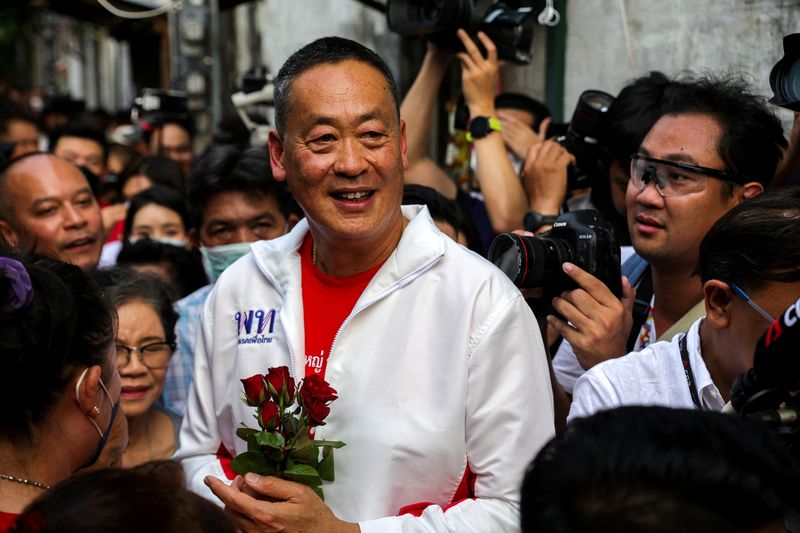 &copy; Reuters. FILE PHOTO: Srettha Thavisin, a well-known local property tycoon as Pheu Thai Party's new adviser was being lined up as another prime ministerial candidate, greets his supporters during the upcoming general election campaign, in Bangkok, Thailand, March 8