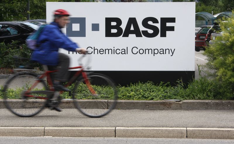 &copy; Reuters. A cyclist rides his bike past the entrance of the BASF plant and former Ciba production site in Schweizerhalle near Basel July 7, 2009.  REUTERS/Christian Hartmann/File Photo