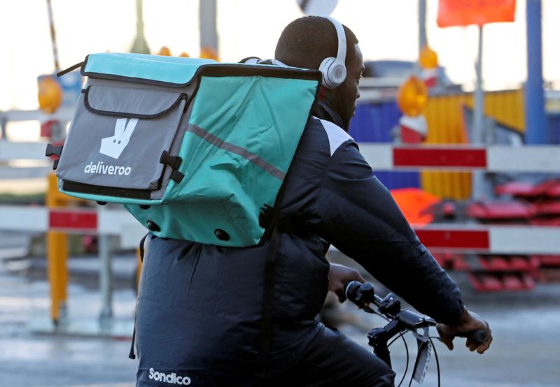 &copy; Reuters. FILE PHOTO: A courier for food delivery service Deliveroo rides a bike in central Brussels, Belgium January 16, 2020. Picture taken January 16, 2020. REUTERS/ Yves Herman/File Photo