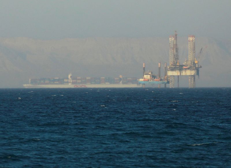 &copy; Reuters. FILE PHOTO: A container ship crosses an oil platform at the Gulf of Suez towards the Red Sea before entering the Suez Canal, outside of Cairo, Egypt September 1, 2020. REUTERS/Amr Abdallah Dalsh/File Photo