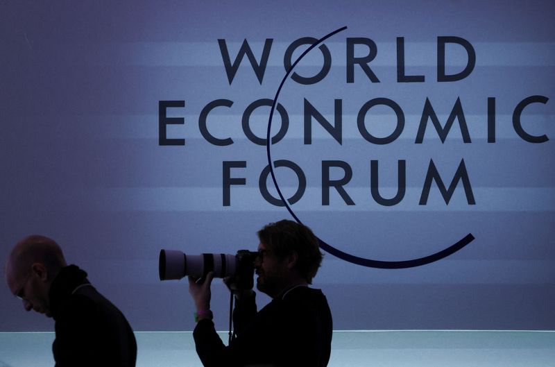 &copy; Reuters. A person takes a photo next to a logo during the 54th annual meeting of the World Economic Forum, in Davos, Switzerland, January 19, 2024. REUTERS/Denis Balibouse/ File Photo