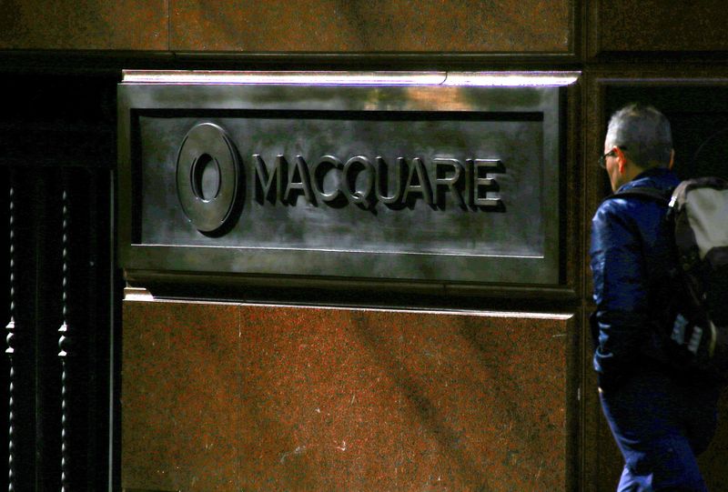 &copy; Reuters. FILE PHOTO: A pedestrian walks past the logo of Australia's biggest investment bank Macquarie Group Ltd which adorns a wall on the outside of their Sydney office headquarters in central Sydney, Australia, July 18, 2017.  Picture taken July 18, 2017. REUTE