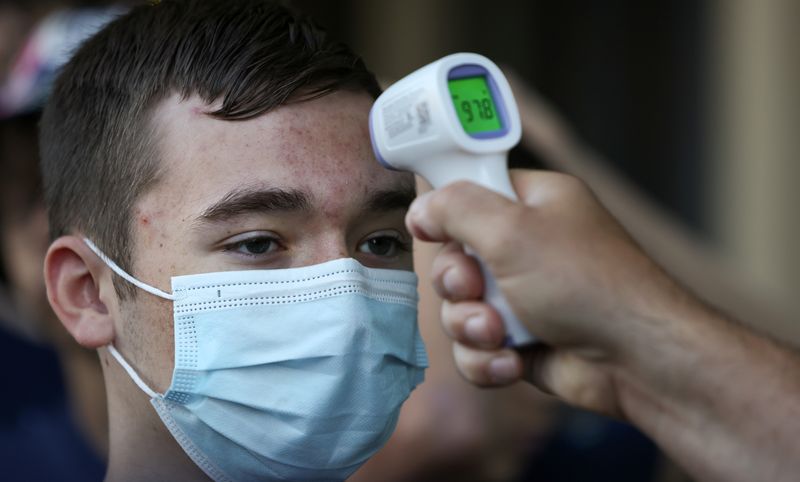 &copy; Reuters. David Rooney, a student at Michigan?s Clarkston Junior High School, gets a temperature check before boarding a tour bus during his 8th grade trip to Washington, in Sterling, VA, U.S., U.S., June 18, 2021. REUTERS/Evelyn Hockstein/File photo