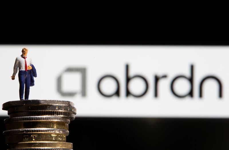 &copy; Reuters. Businessman toy figure is placed on U.K. Pound coins in front of displayed Abrdn logo in this illustration taken, November 8, 2021. REUTERS/Dado Ruvic/Illustration