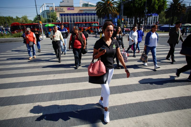 &copy; Reuters. Pedestrians are seen on the streets in Mexico City, Mexico March 24, 2020. REUTERS/Gustavo Graf/File Photo