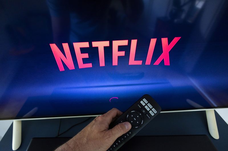 © Reuters. A Netflix logo is shown on a TV screen ahead of a Swiss vote on a referendum called 