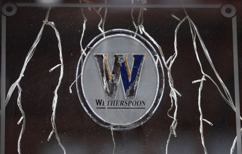 &copy; Reuters. FILE PHOTO: Signage is seen on a window of a closed Wetherspoon pub in London, Britain, October 16, 2020. REUTERS/Toby Melville/File Photo
