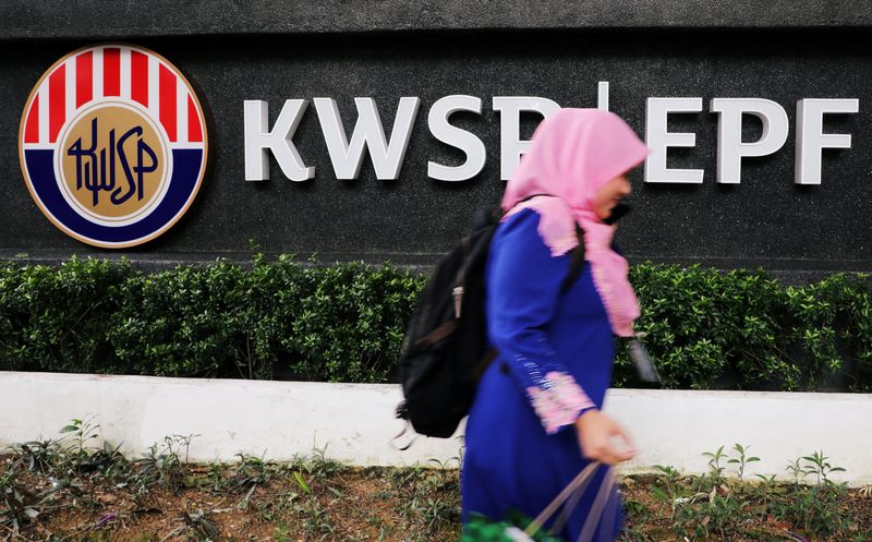 &copy; Reuters. FILE PHOTO: A woman walks past the Employees' Provident Fund (EPF) headquarters in Kuala Lumpur, Malaysia September 5, 2019.  REUTERS/Lim Huey Teng/File Photo