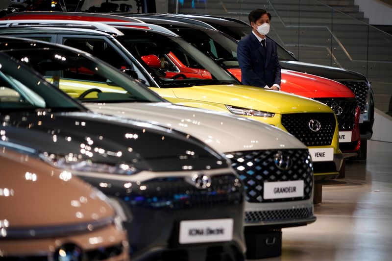 © Reuters. An employee wearing a mask to prevent contracting the coronavirus disease (COVID-19) waits for custormers next to a Hyundai Motor's vehicle at Hyundai Motor Studio in Goyang, South Korea, April 21, 2020. REUTERS/Kim Hong-Ji