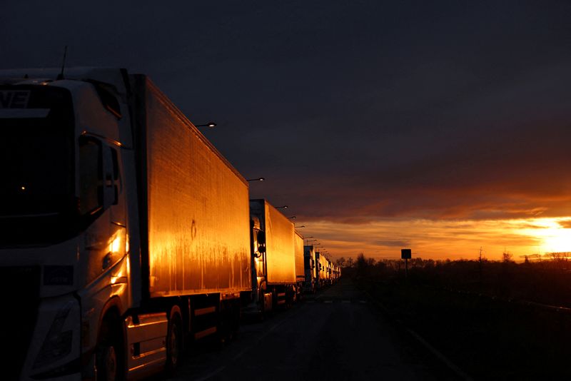 &copy; Reuters. Trucks queue in line at sunrise as French farmers block truck access to the SOCAMIL, the purchasing center for Leclerc, as part of their protest over price pressures, taxes and green regulation, grievances shared by farmers across Europe, in Castelnaudary
