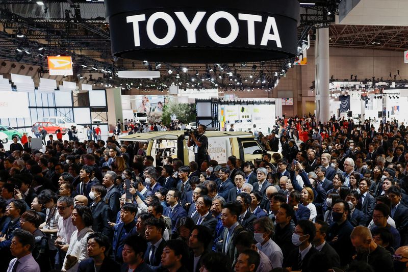&copy; Reuters. Attendees listen as President, CEO and Member of the Board of Directors at Toyota Motor Corporation Koji Sato holds a press briefing during a press day of the Japan Mobility Show 2023 at Tokyo Big Sight in Tokyo, Japan October 25, 2023.  REUTERS/Issei Kat